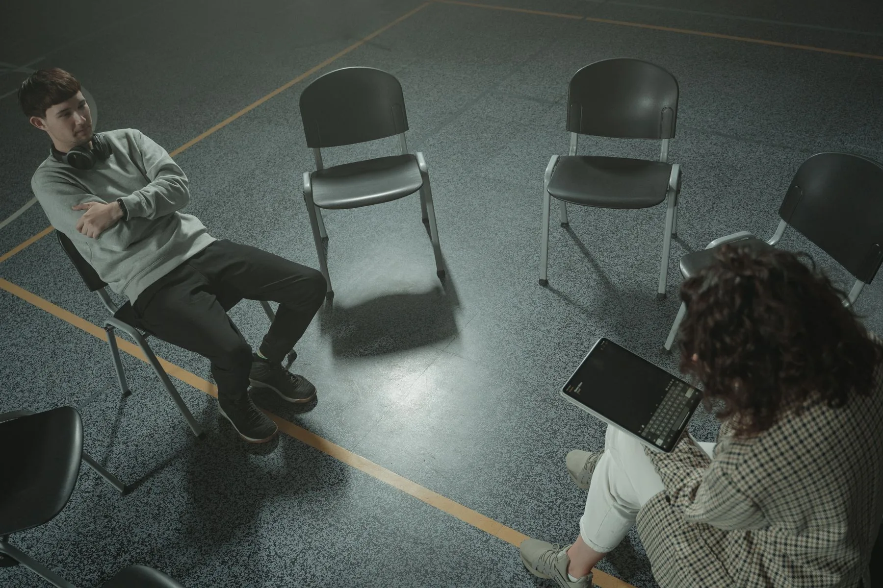 Counselor speaking with a patient in a calm therapy room